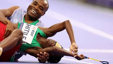 Franck Fife / AFP Namibia's Lahja Ishitile collapsed on the  racetrack alongside her guide Sem Shimanda after winning the Women's 400m T11 Final at the Paris Paralympic Games - Saturday 31 August 2024