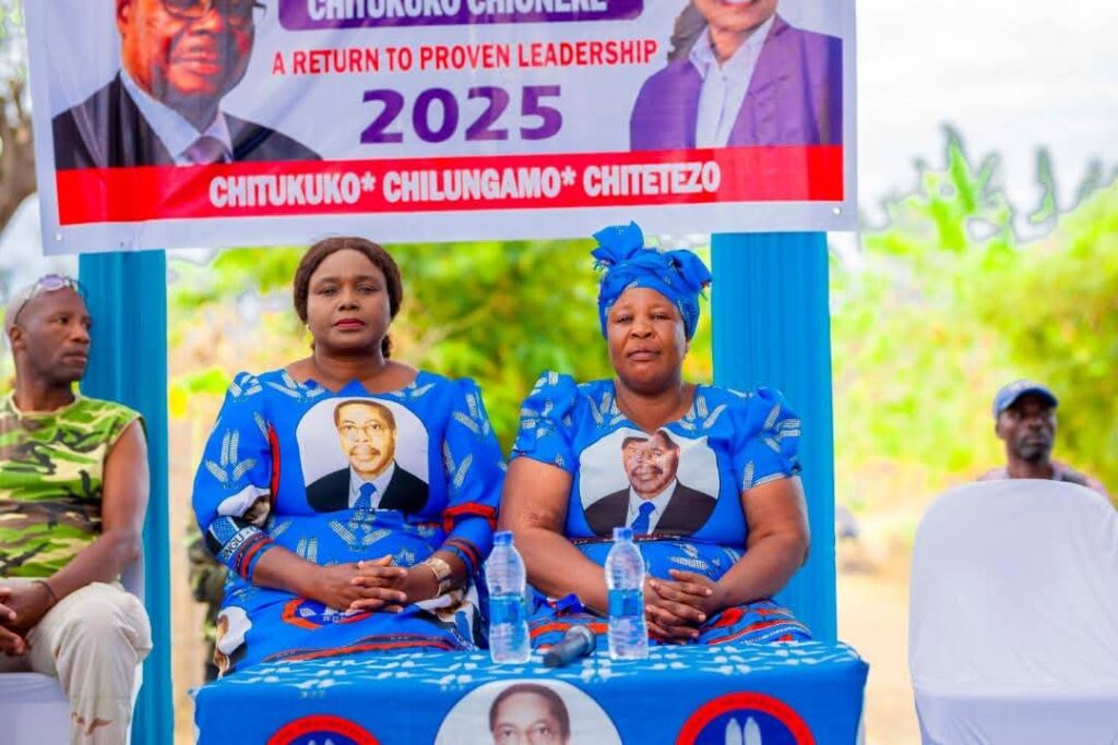 Two DPP heavy political figures women siting at the front during a political rally waiting to address supporters