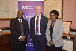 swinney (centre) flanked by masi (left) and nbm development bank chief operating officer esnat kamudoni (right)