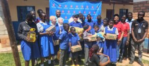 UGI donates K3 million food supplies to visually impaired learners chibwe and ugi officials pose with saint maria goretti students and staff (002)