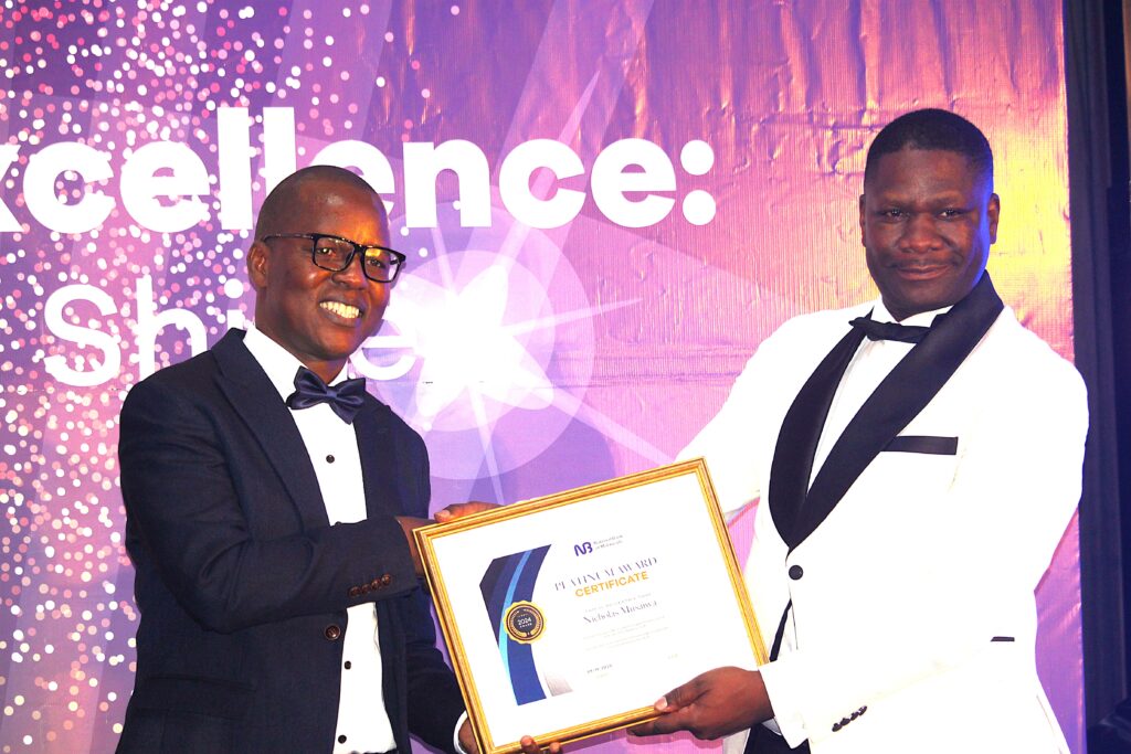 NBM plc awards 8 outstanding employees jiya (right) presenting the certificate to musaiwa (002)