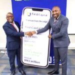 nyirenda (left) handing over a dummy cheque to dossi (002)