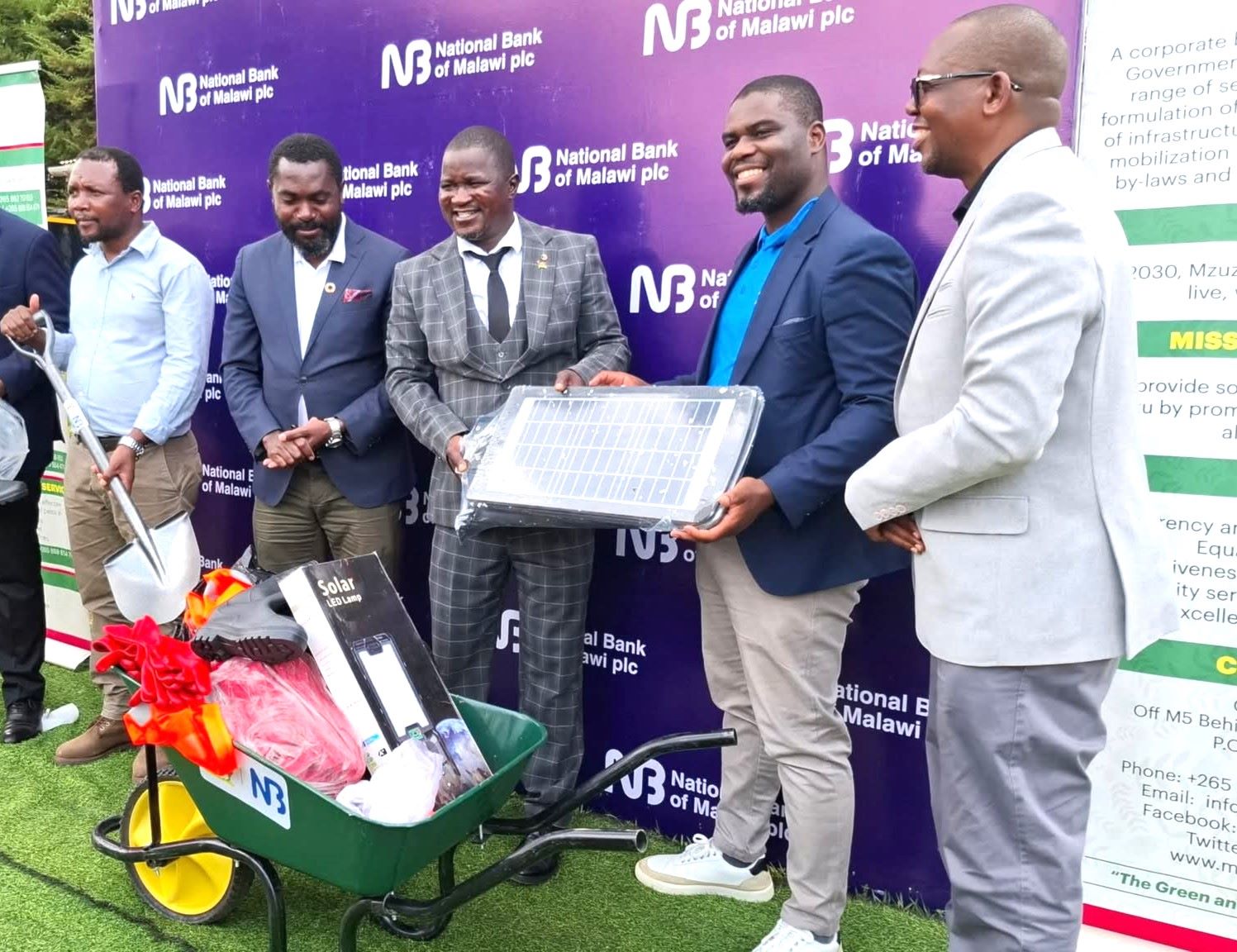 patsanja (second right) and mzuzu service manager samson mzungu handing over sanitation equipments to moses (middle) as other mcc officials look on (002)
