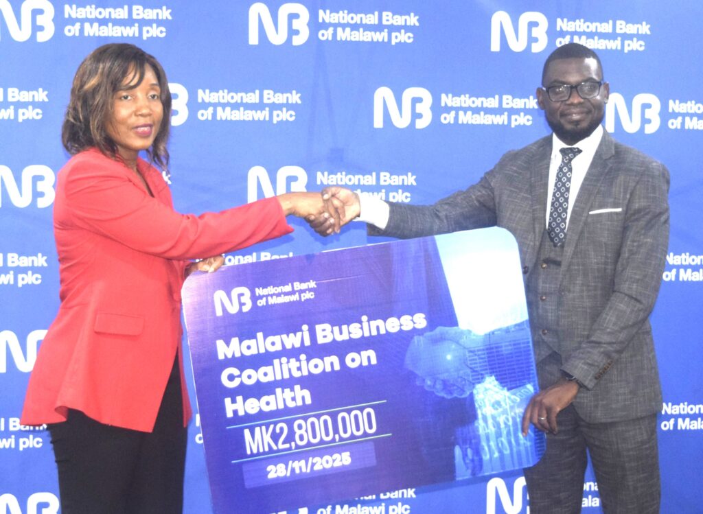 chakhoma (right) hands over a dummy cheque to mphwatiwa (002)