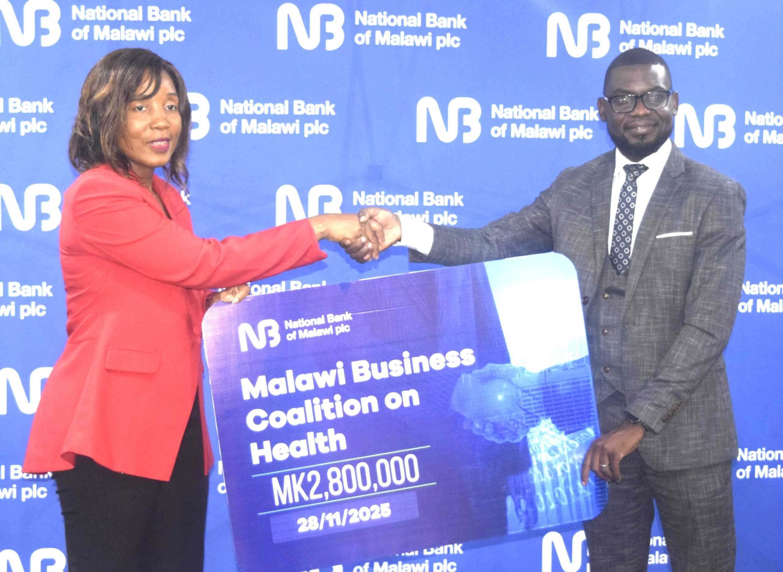 chakhoma (right) hands over a dummy cheque to mphwatiwa (002)