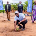 chinkhandwe gestures after planting a tree