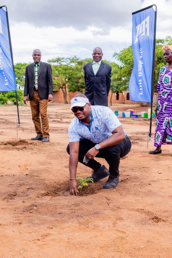 chinkhandwe gestures after planting a tree