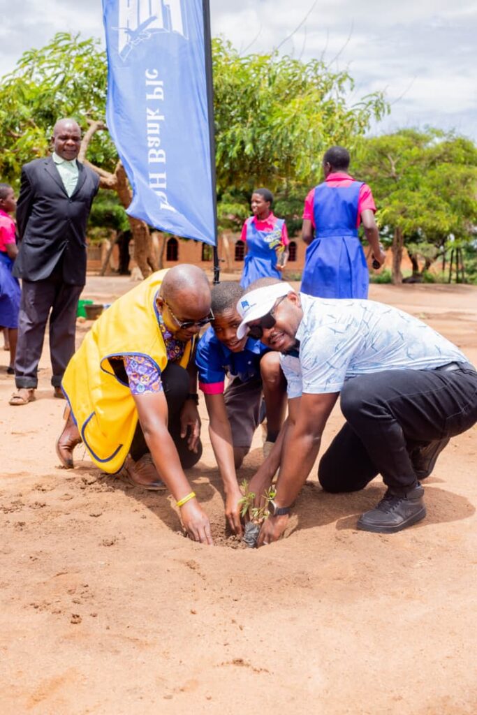 chinkhandwe (right) and kuyeri (left) and a pupil plant a tree