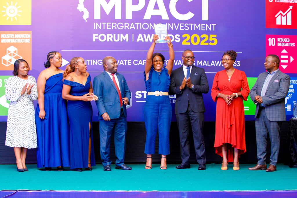 NBM Development Bank bags Industrialisation Catalyst Award nbmdbl chief operating officer esnat kamudoni hoisting the award while flanked by bank officials (002)