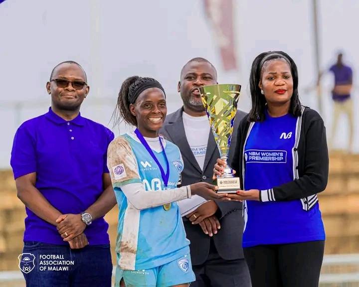 hon. wiskies presenting the trophy to silver strikers ladies captain nyirongo (002)