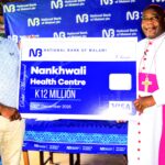 NBM plc renovates Nankhwali Health Centre in Mangochi jiya (left) handing over the k12 million cheque to rt. rev sitima (1) (002)