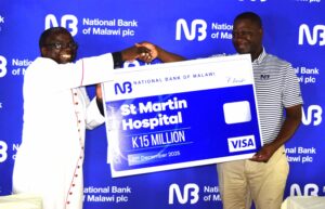 jiya (right) handing over a dummy cheque to rev. mchakama 092025 (002)