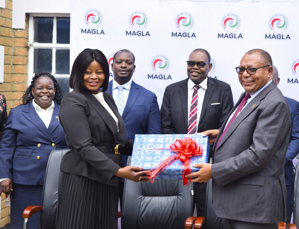 mijiga (left) handing over a gift to partridge while other magla officials look on (002)