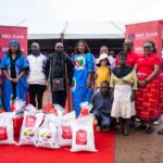 the first lady (middle) poses with nbs bank and beam trust officials and beneficiries with the hampers