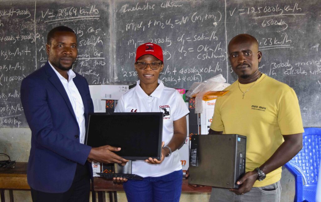muhire (right) and zimba (centre) handing over ict essentials to kanjedza intensive school official