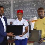 muhire (right) and zimba (centre) handing over ict essentials to kanjedza intensive school official