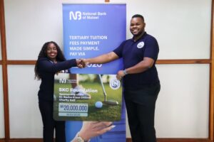 Gwembere (left) handing over a K20 million dummy cheque to Sean Chilima