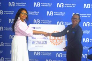 NBM plc gives K12 million to Rotary Club of Blantyre to support rural healthcare 2 malikula(right) handing over the cheque to khomani (002)