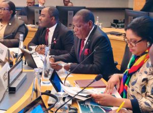 Officials seated at a conference table with microphones and documents during the Spring Meetings 2024
