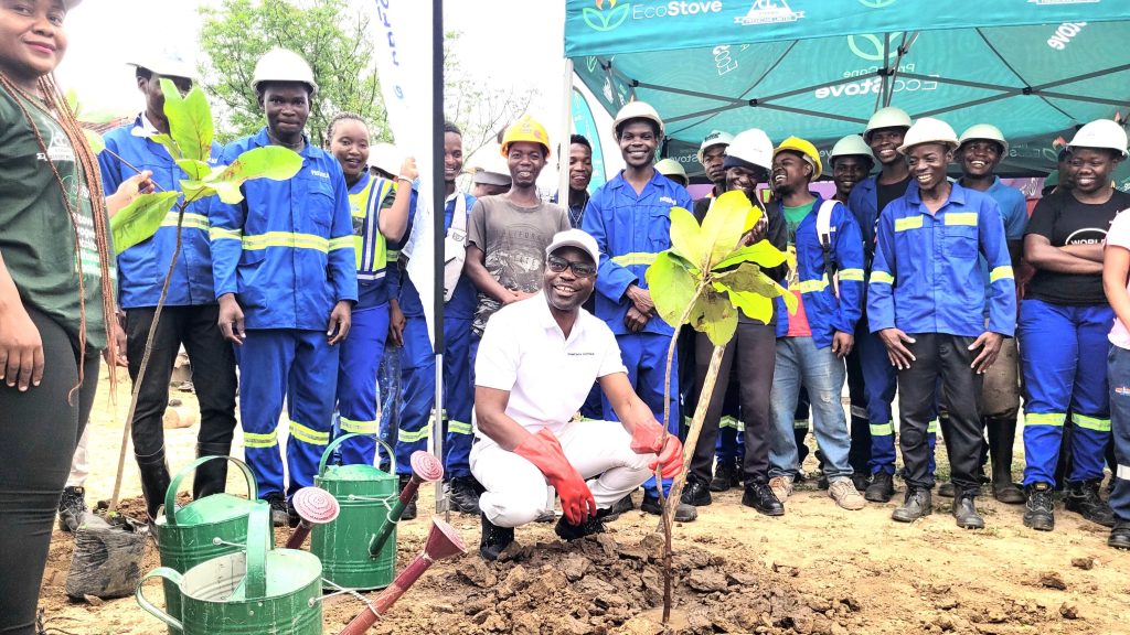 Mkomaanthu crouching poses with his team after planting a tree 002