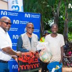 Ulaya left and Chidiwa centre hand over donated items to a flood victim 002