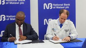 NBM plc commits K317 Million for Malamulo Hospital power project Katsala (Left) signing the MoU with Sherwin (002)