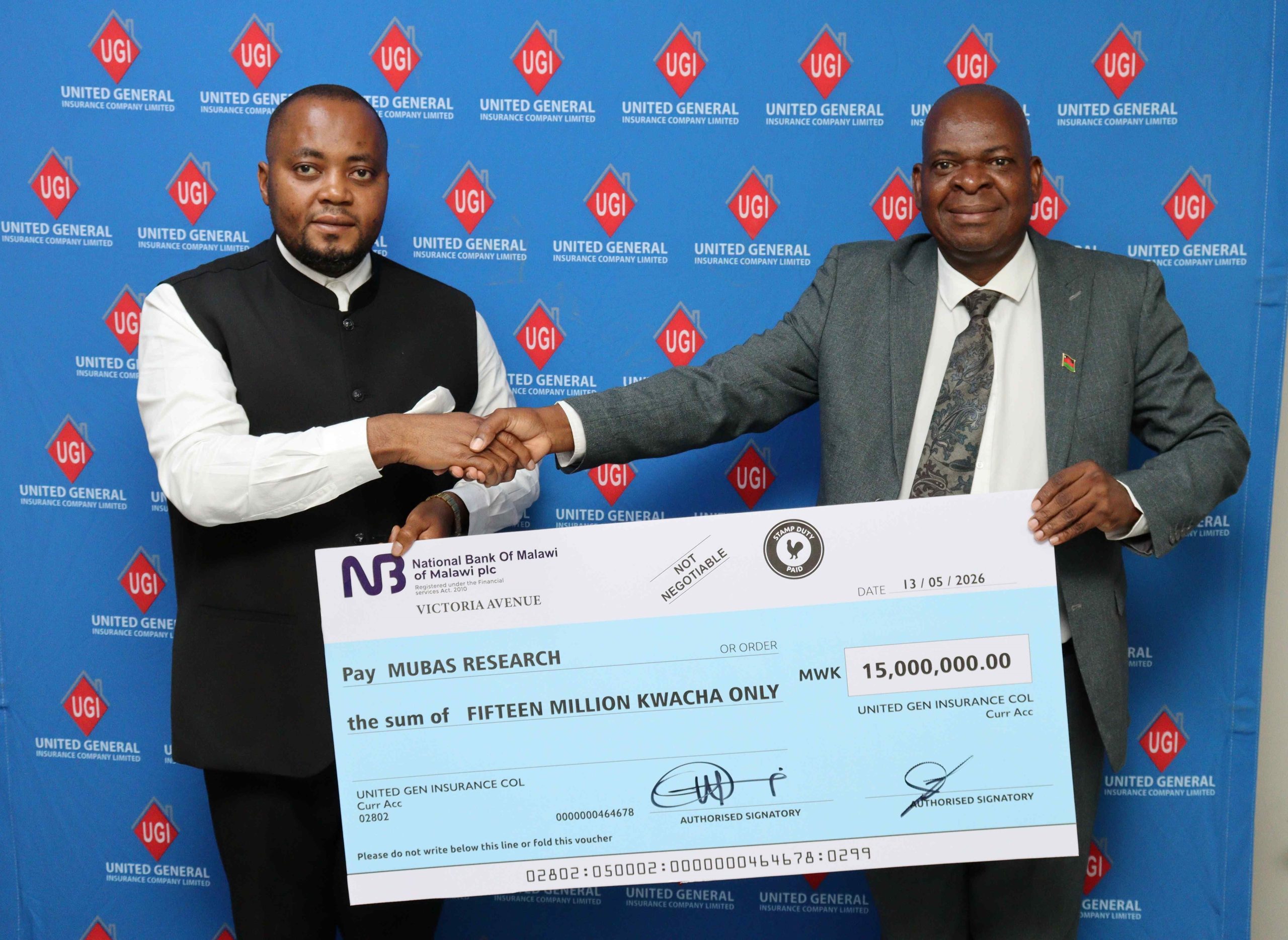 Chibwe left handing over a dummy cheque to Thole 002 scaled