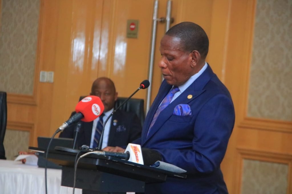 Joseph Mwanamvekha speaking at a podium during the National Consultative Workshop