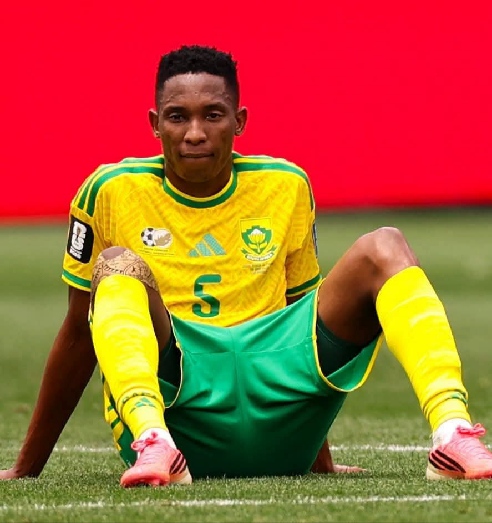 South African player sits on the pitch in disappointment after the late defeat to Canada