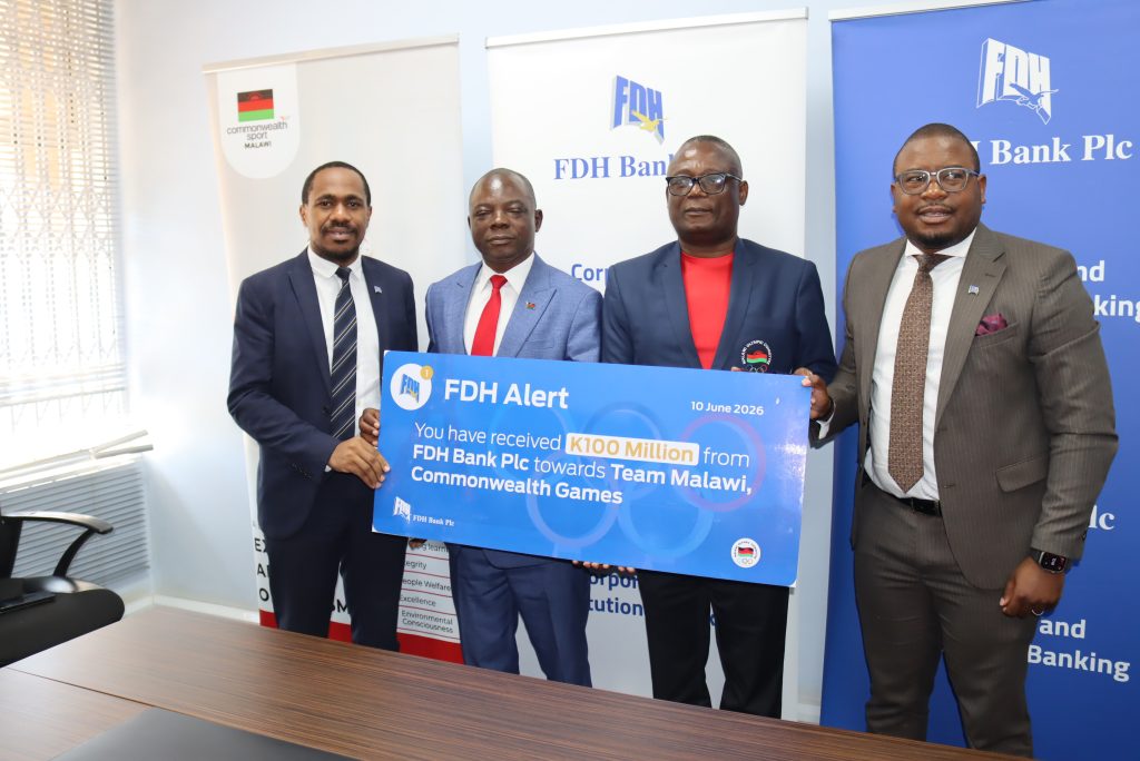 Khamula left presents the dummy cheque to Sports Ministry PS Jameson Ndalama second left and Kakhuta Banda second right with FDH Banks Senior Manager Eugene Chinkhandwe right