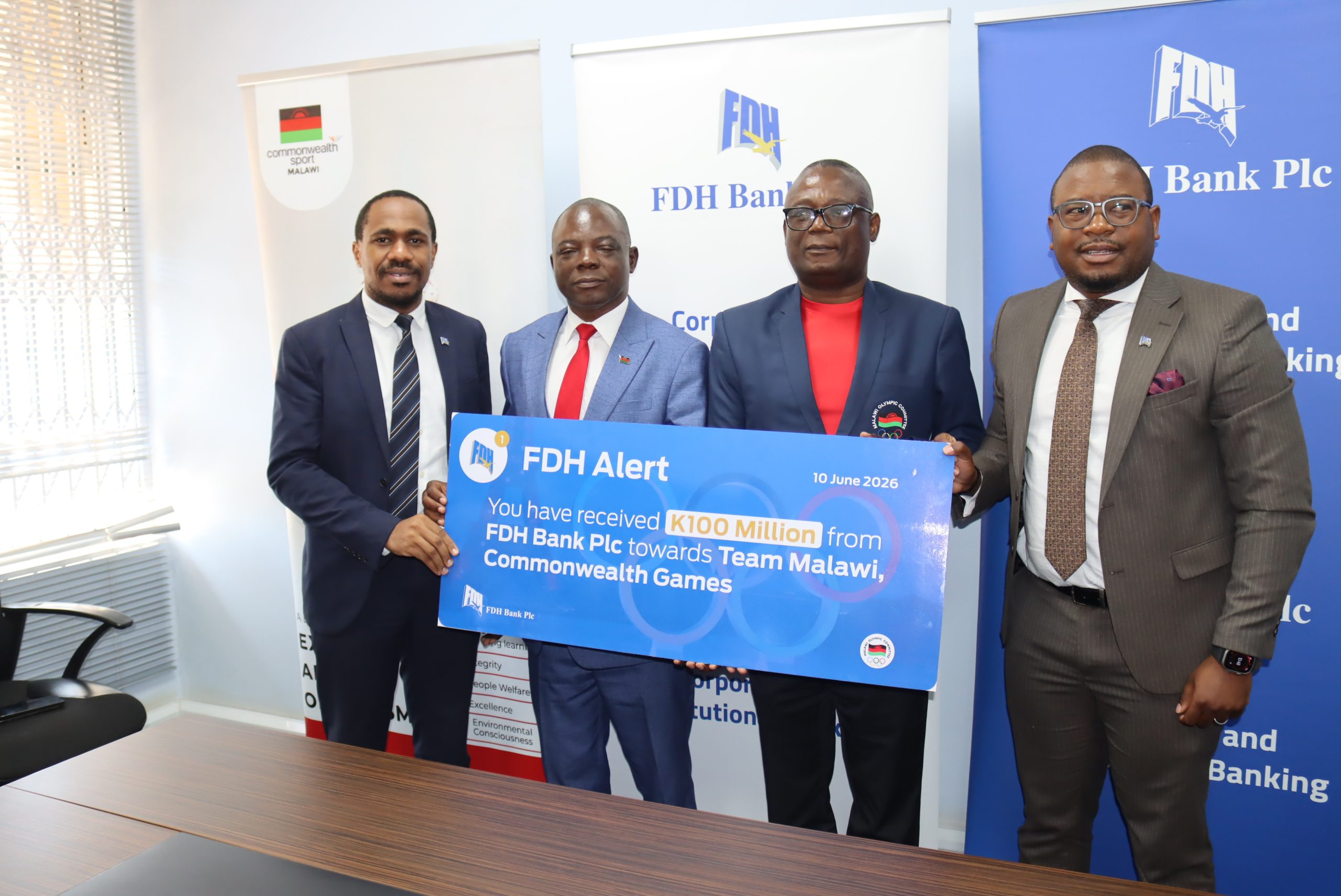 Khamula left presents the dummy cheque to Sports Ministry PS Jameson Ndalama second left and Kakhuta Banda second right with FDH Banks Senior Manager Eugene Chinkhandwe right scaled