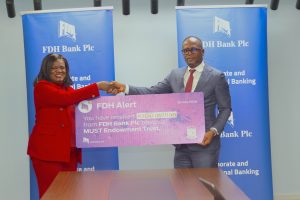 FDH Bank Deputy Managing Director George Chitera Right handing over a dummy cheque to Malata 002