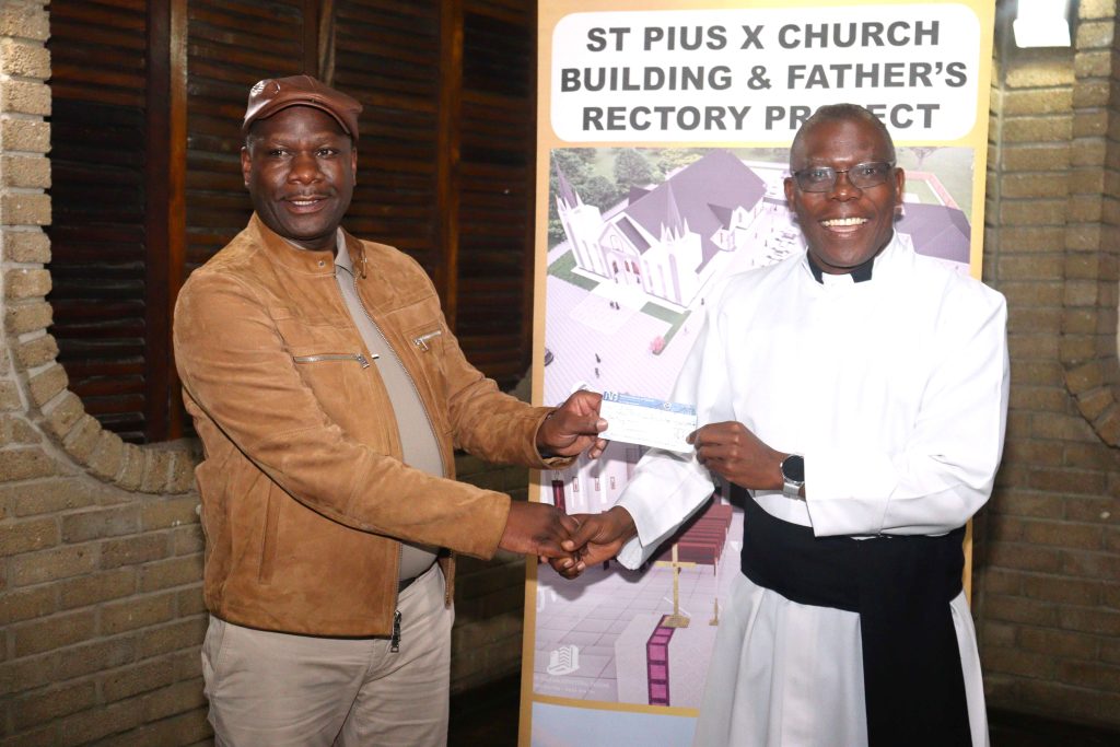 Jiya Left presenting the cheque to Father Kantembe 002