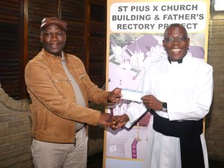 Jiya Left presenting the cheque to Father Kantembe 002