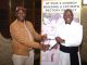 Jiya Left presenting the cheque to Father Kantembe 002