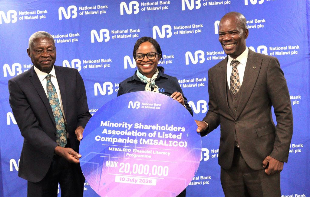 Mitole Center handing over a dummy cheque to Harawa Right flanked by George Sambakunsi of MISALICO 002