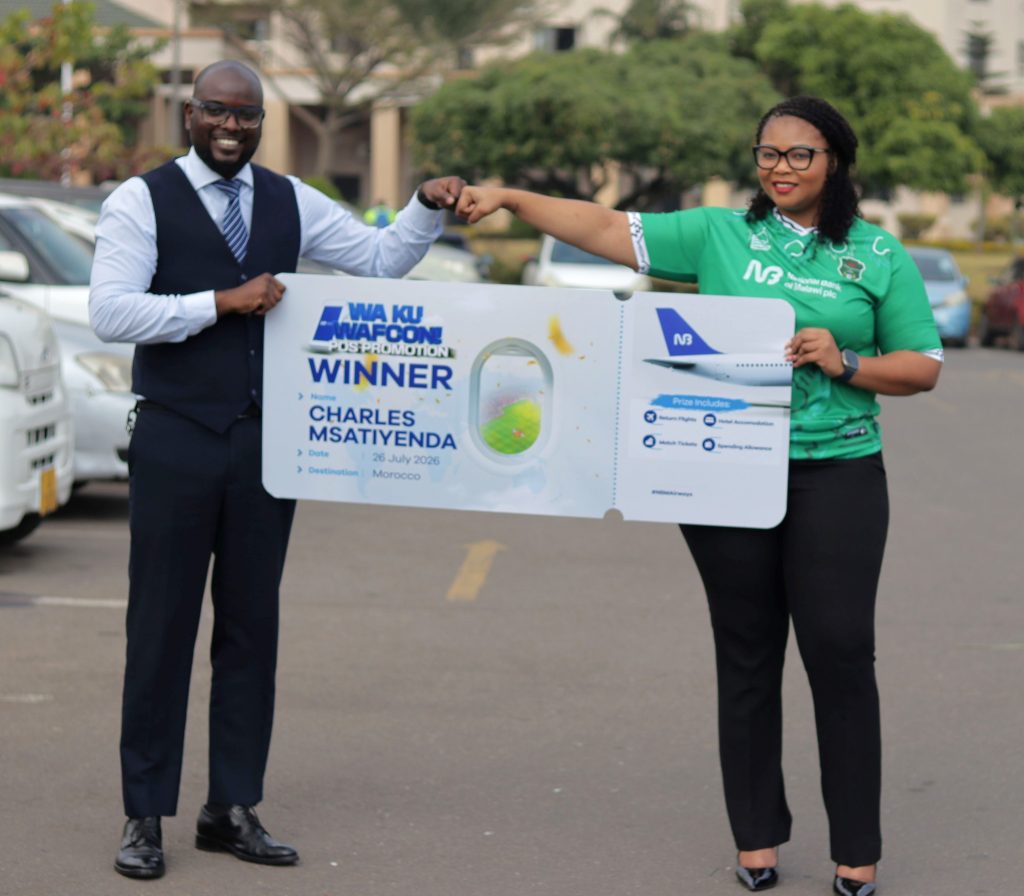 Mphepo Hiwa Right handing over a dummy air ticket to Msatiyenda 002