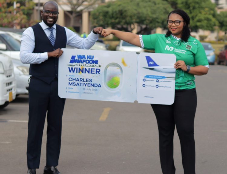 Mphepo Hiwa Right handing over a dummy air ticket to Msatiyenda 002