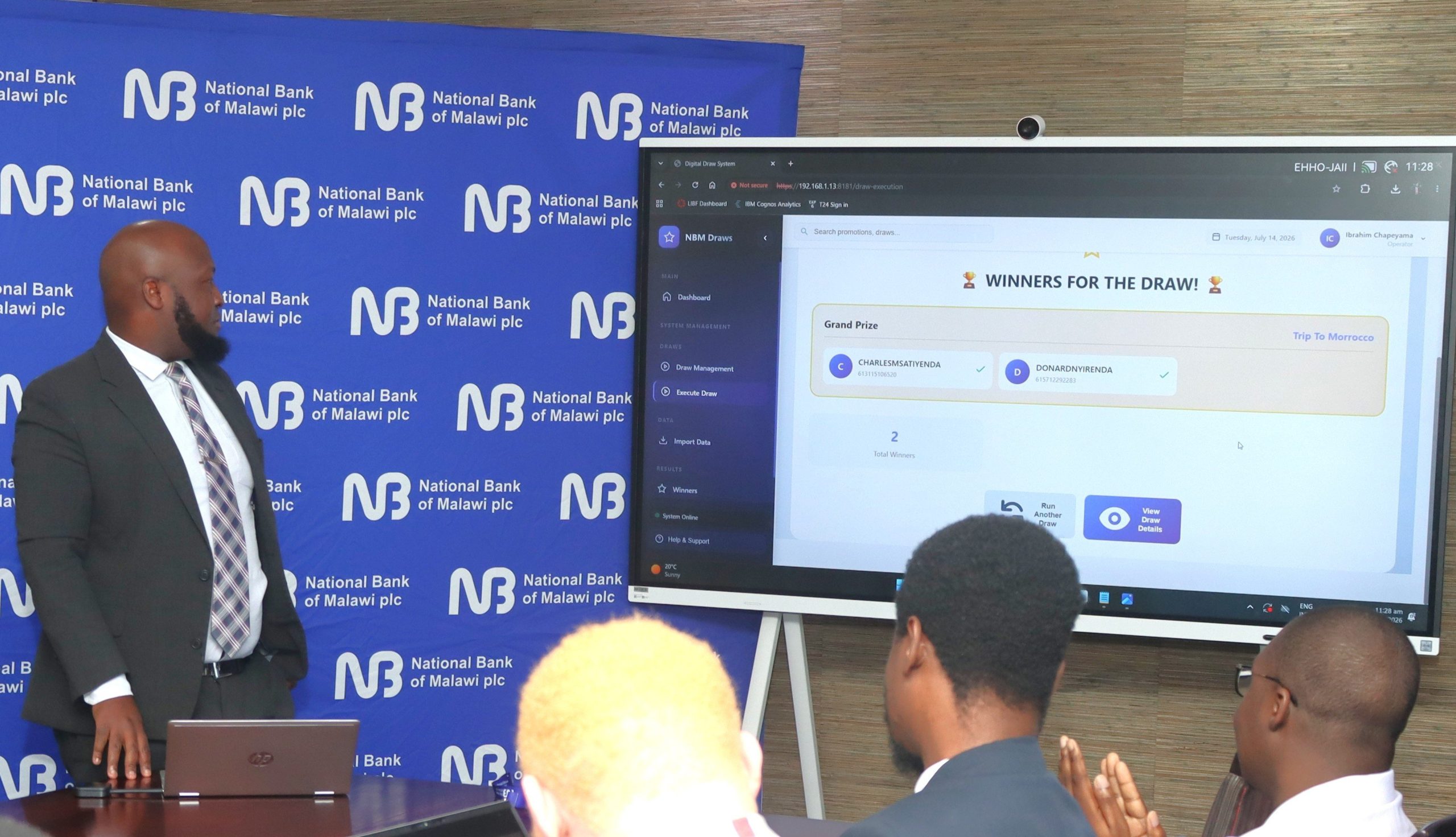 NBM plc Products Development and Strategy Manager Ibrahim Chapeyama conduct the draw 002 scaled