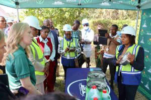 Minister applauds PressCane clean cooking initiative | Malawi Freedom Network Press Cane Sales and Marketing Manager Mercy Kamanga right explaining how the EcoStove works scaled