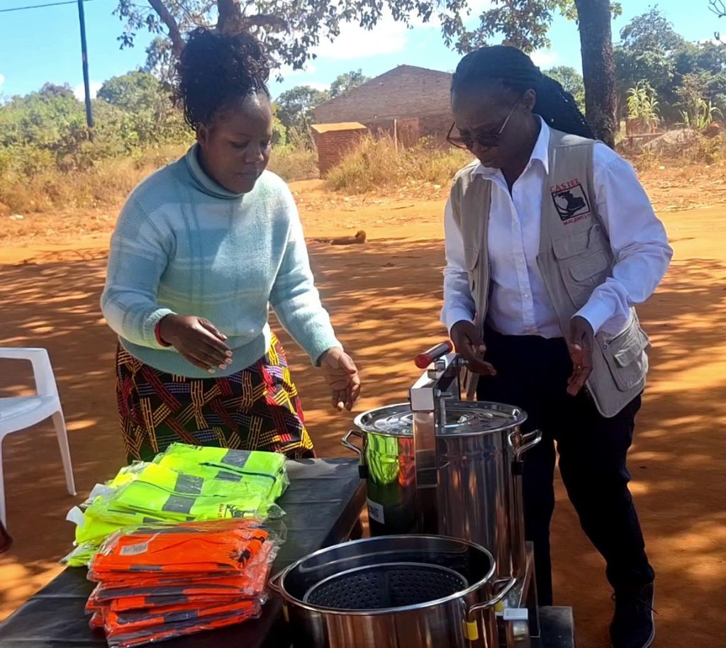 Zimba right presents the items to Nyirenda