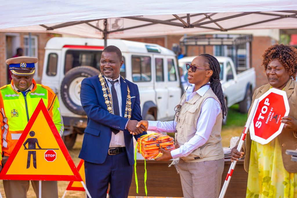 Zimba second right presents road safety materials to the Mayor