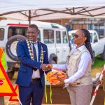 Zimba second right presents road safety materials to the Mayor