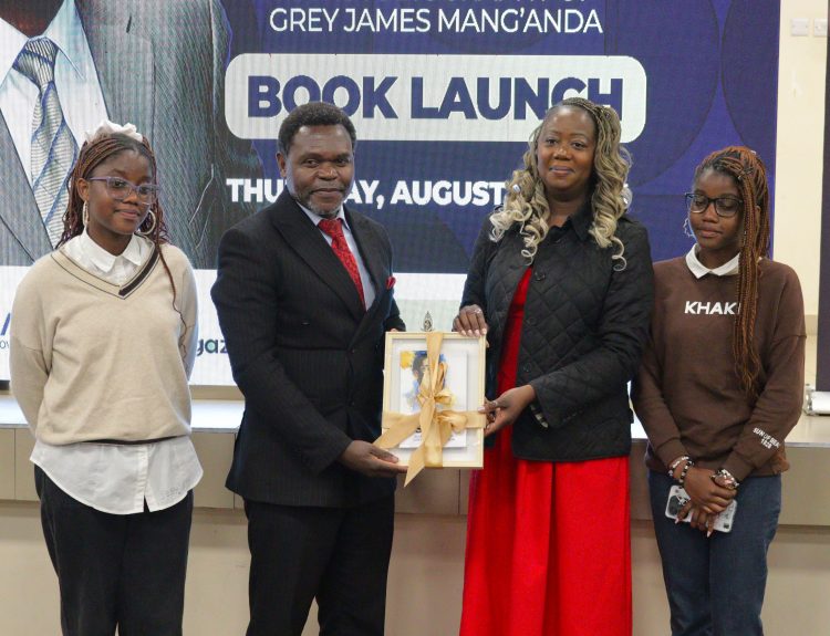 MUBAS Deputy Vice Chancellor Professor Ishmael Kosamu 2nd Left presenting the book Nyasulu and other family members 002