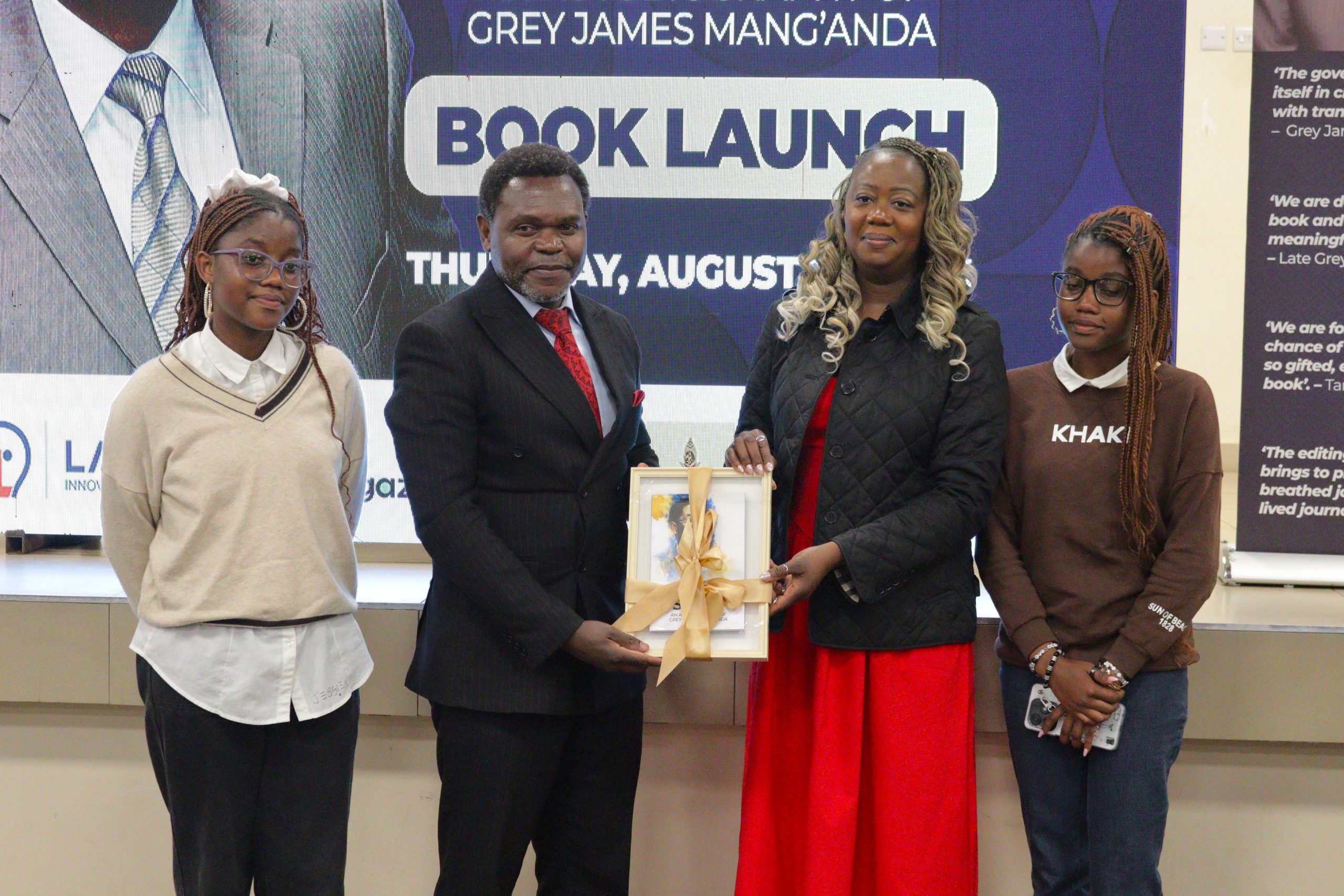 MUBAS Deputy Vice Chancellor Professor Ishmael Kosamu 2nd Left presenting the book Nyasulu and other family members 002 scaled