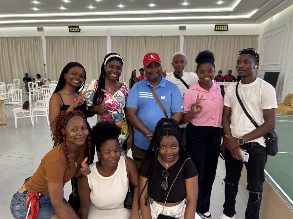 Masi-in-a-red-cap-poses-with-the-supporters-during-the-party