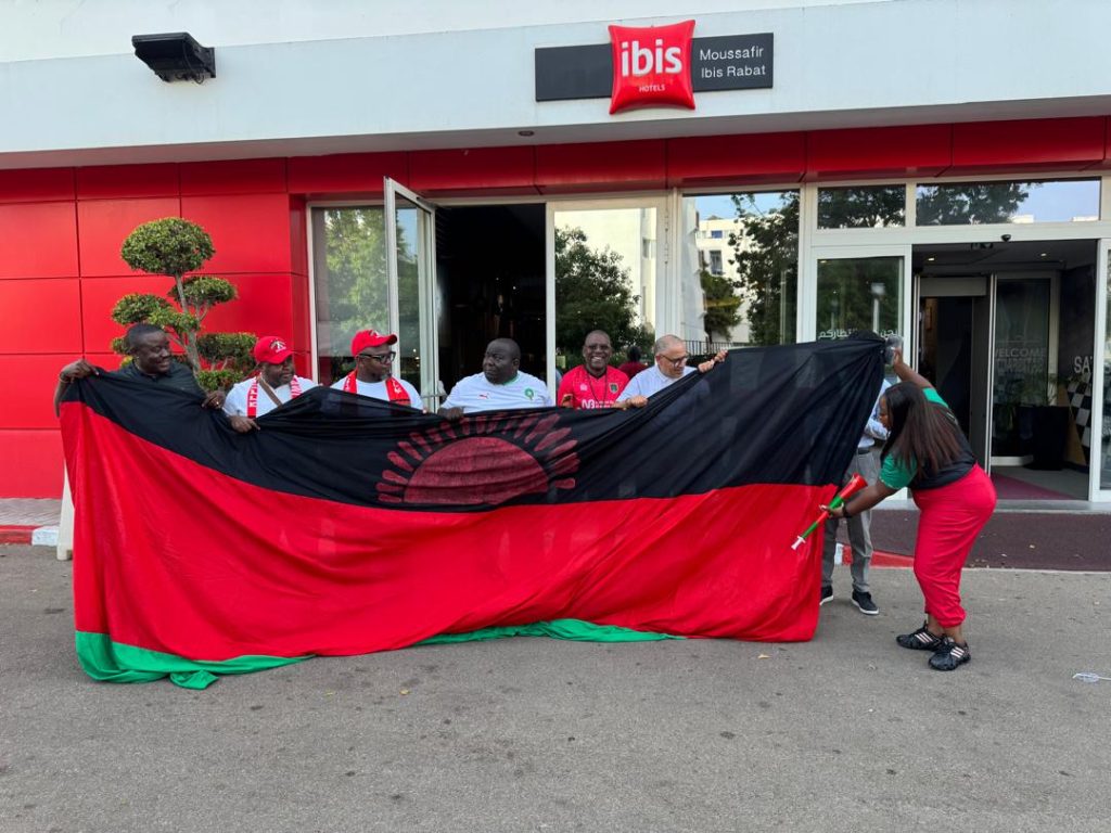 NBM plc flies customers to Morocco to boost Scorchers support in Morocco 2 National-pride-Dossi-checks-the-national-flag-with-Scorchers-supports-in-Rabat-Morocco.