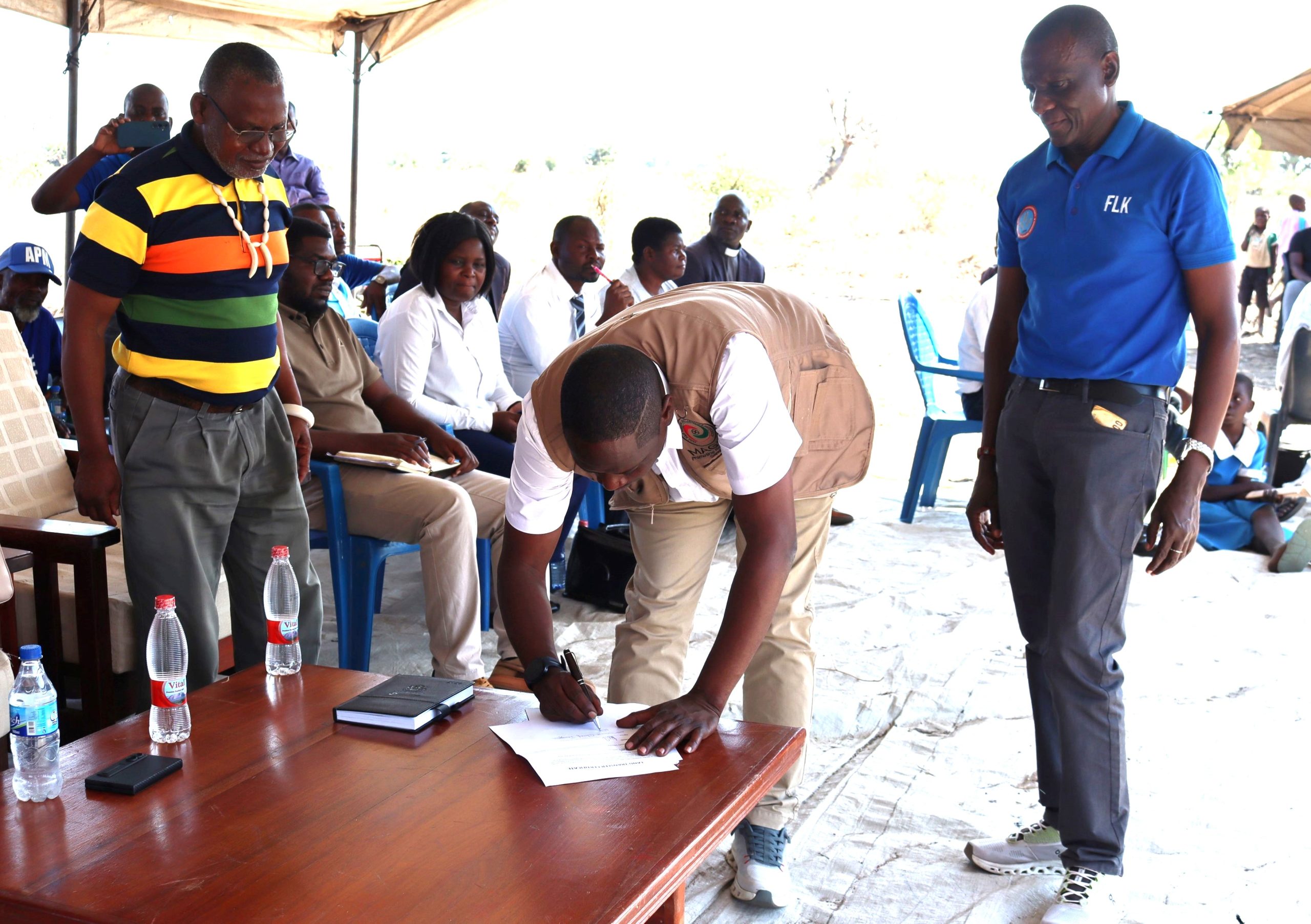 MpulukaCentre signing off the land deal alongside senior TA Tengani Left and Kasaila Right 002 scaled