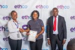Chakaniza left presents a certificate to Ella Chimbalanga centre as Mhone looks on