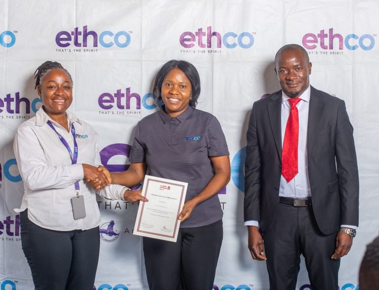 Chakaniza left presents a certificate to Ella Chimbalanga centre as Mhone looks on